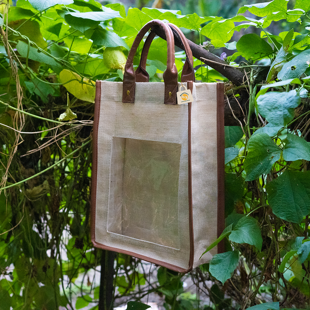 Natural juco gift bag with brown handles and a clear window set into the front panel