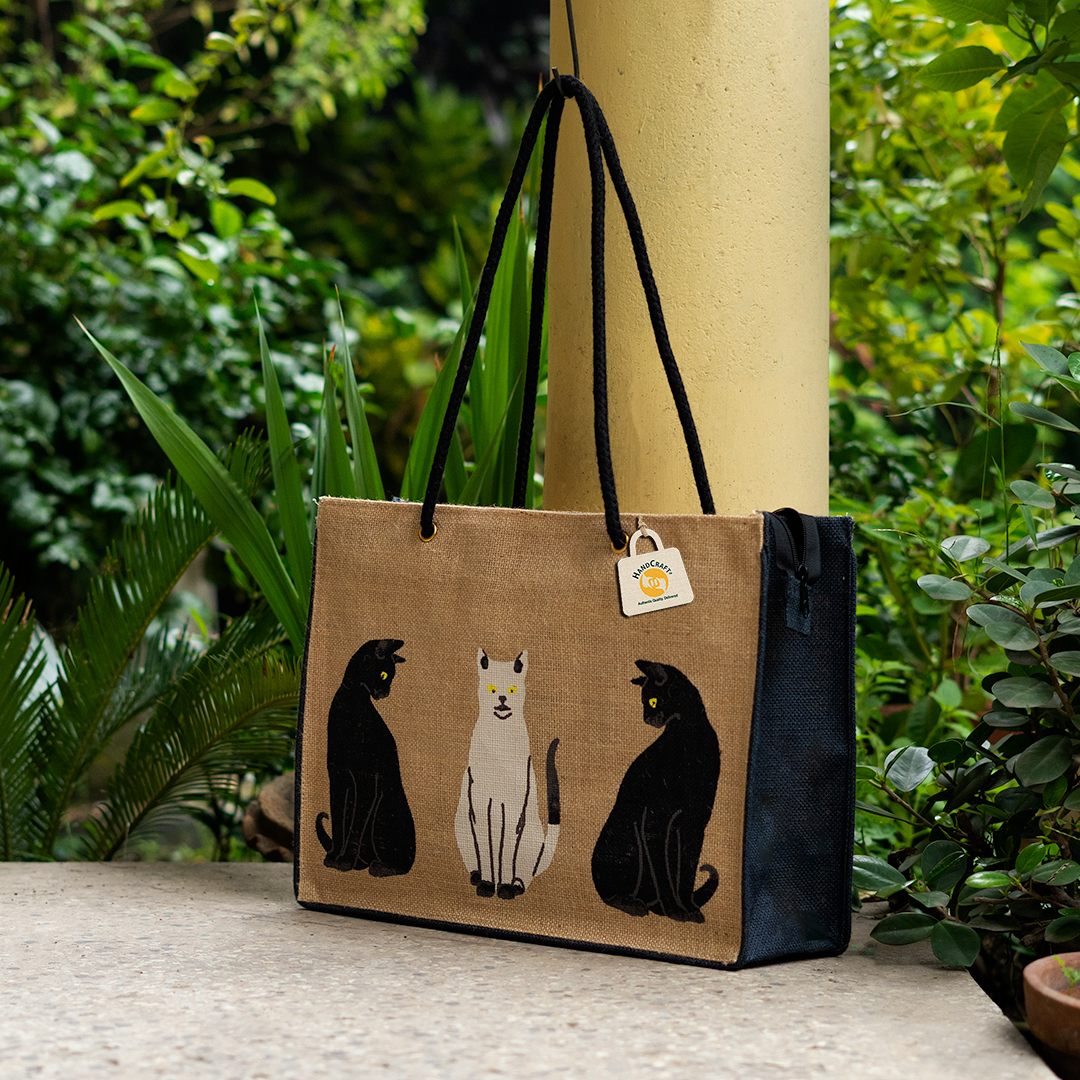 Natural jute tote with long dark handles and a cat print