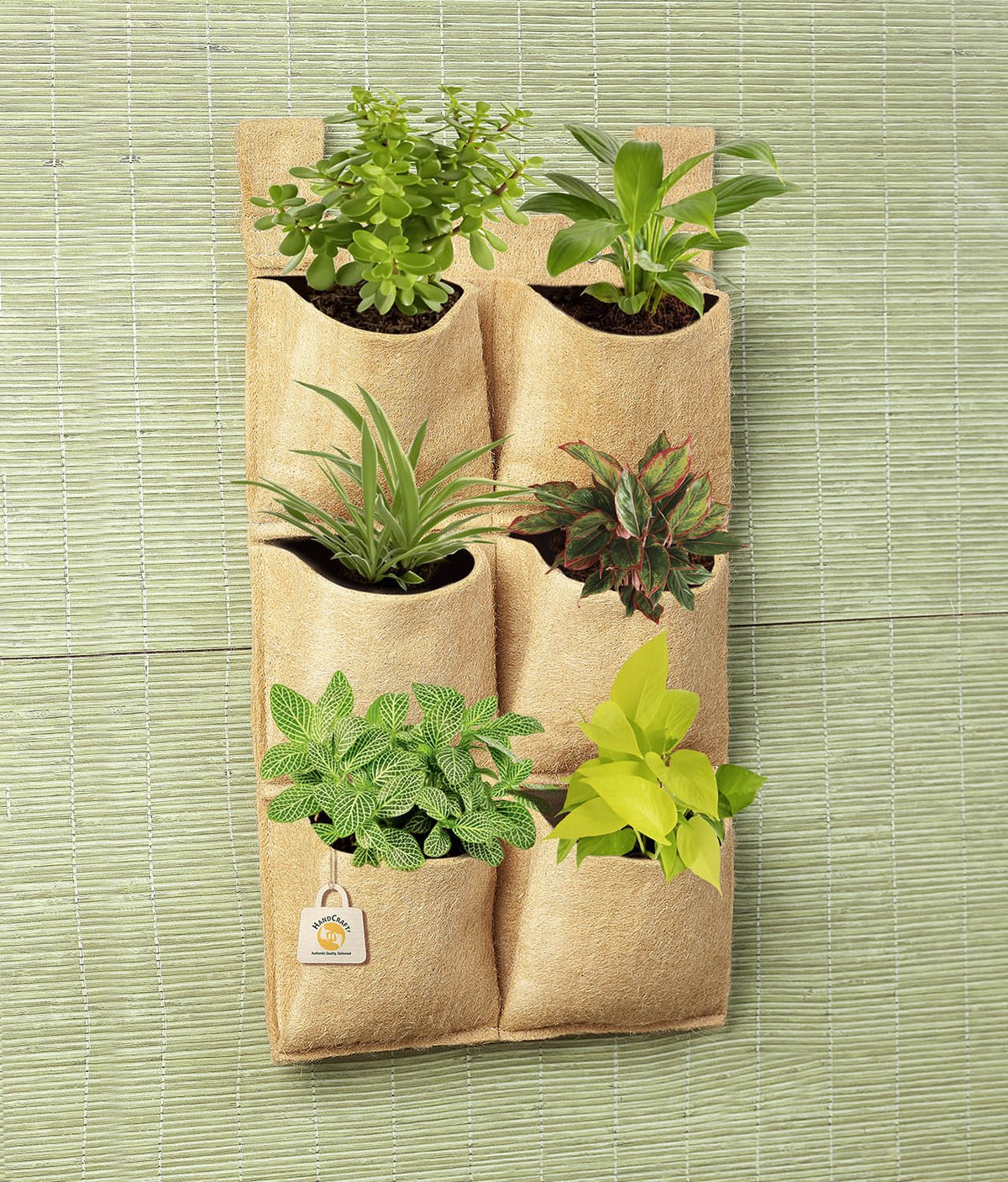 Hanging planter with six pockets containing small plants.