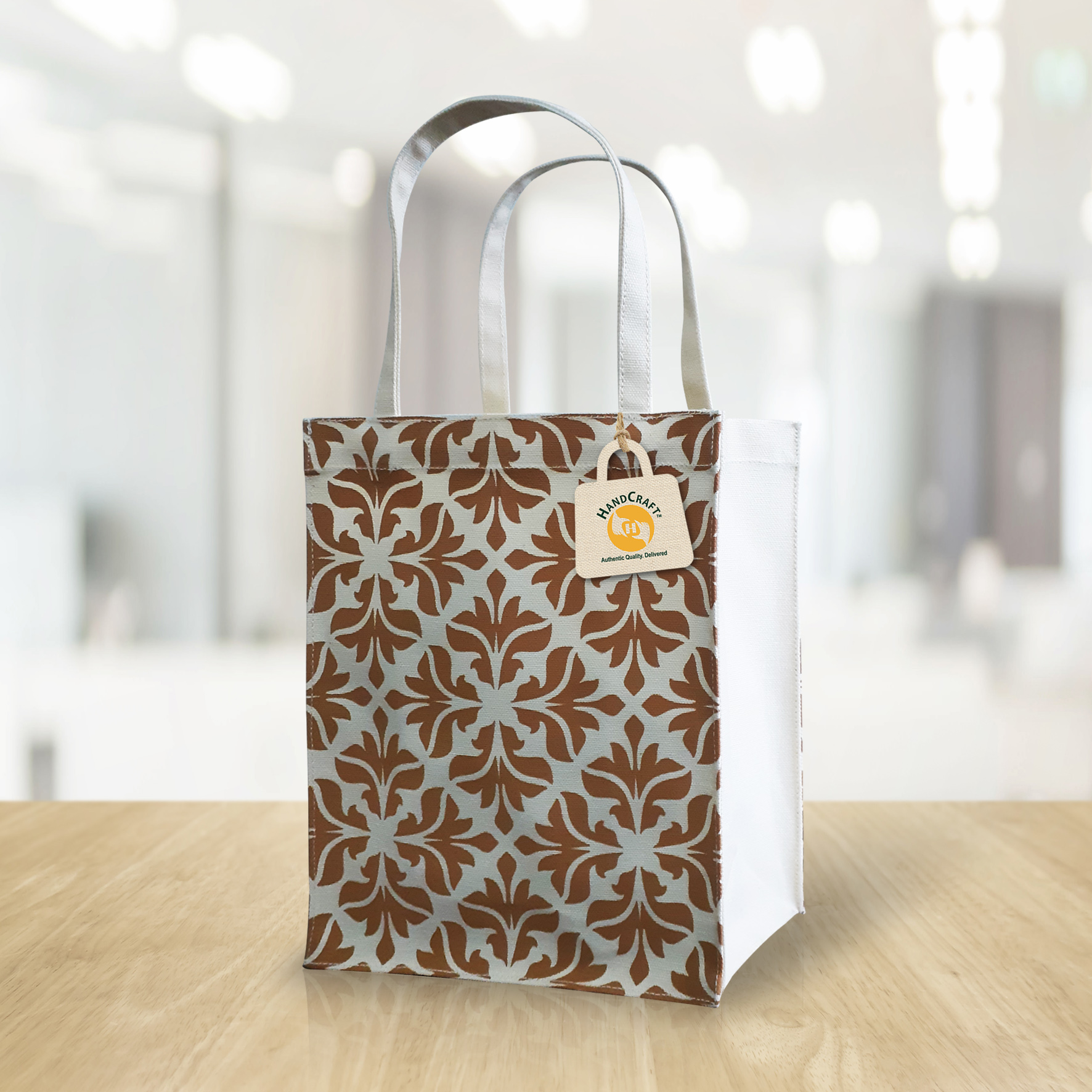 Bag with an all-over brown floral print and pale handles.