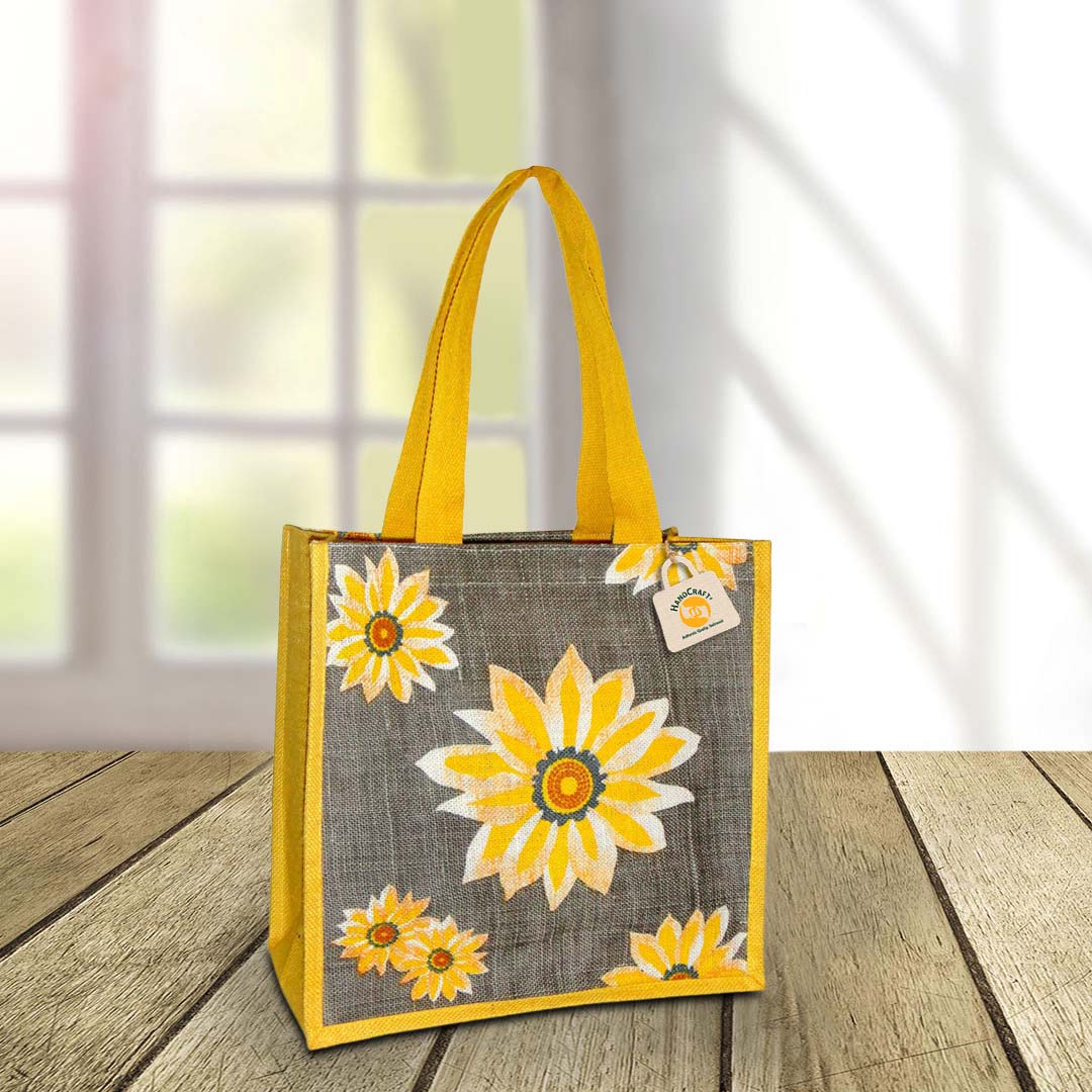Grey tote with a yellow daisy print and yellow handles.