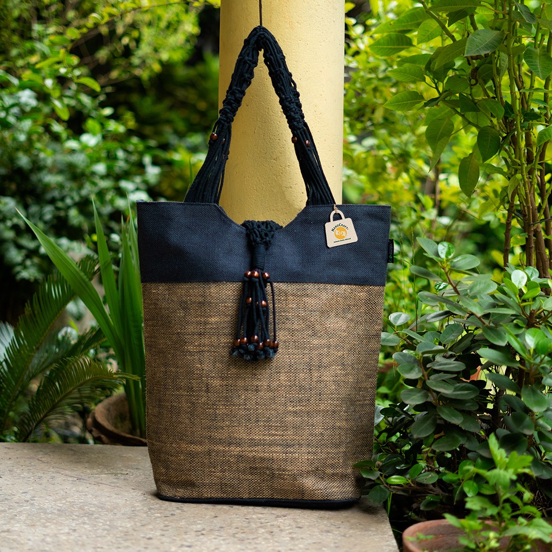 Brown and black shoulder bag with decorative trim.