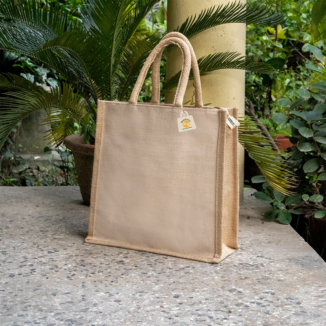 Plain natural-colour jute bag with padded rope handles and side gussets.