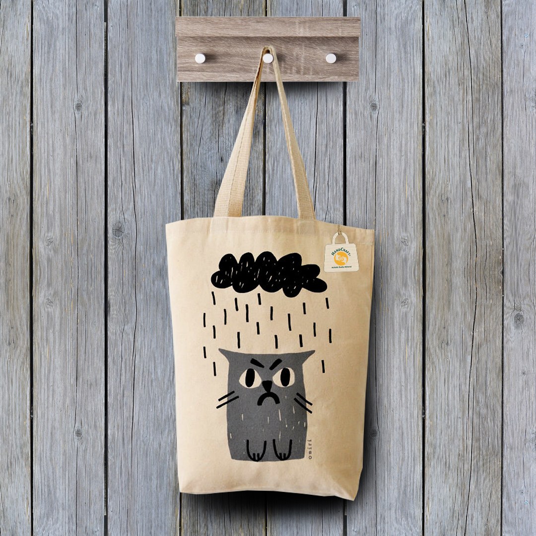 Long-handled fabric tote with a cat and rain-cloud print.