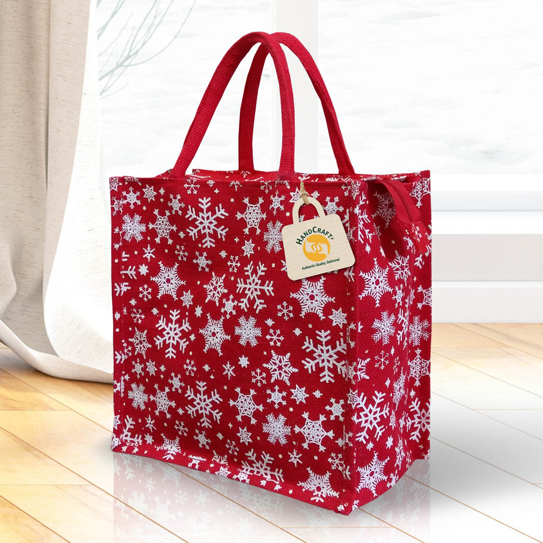 Red bag with a white snowflake print and red handles.