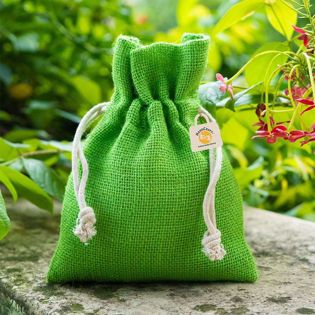 Green jute drawstring pouch with a white cord closure.