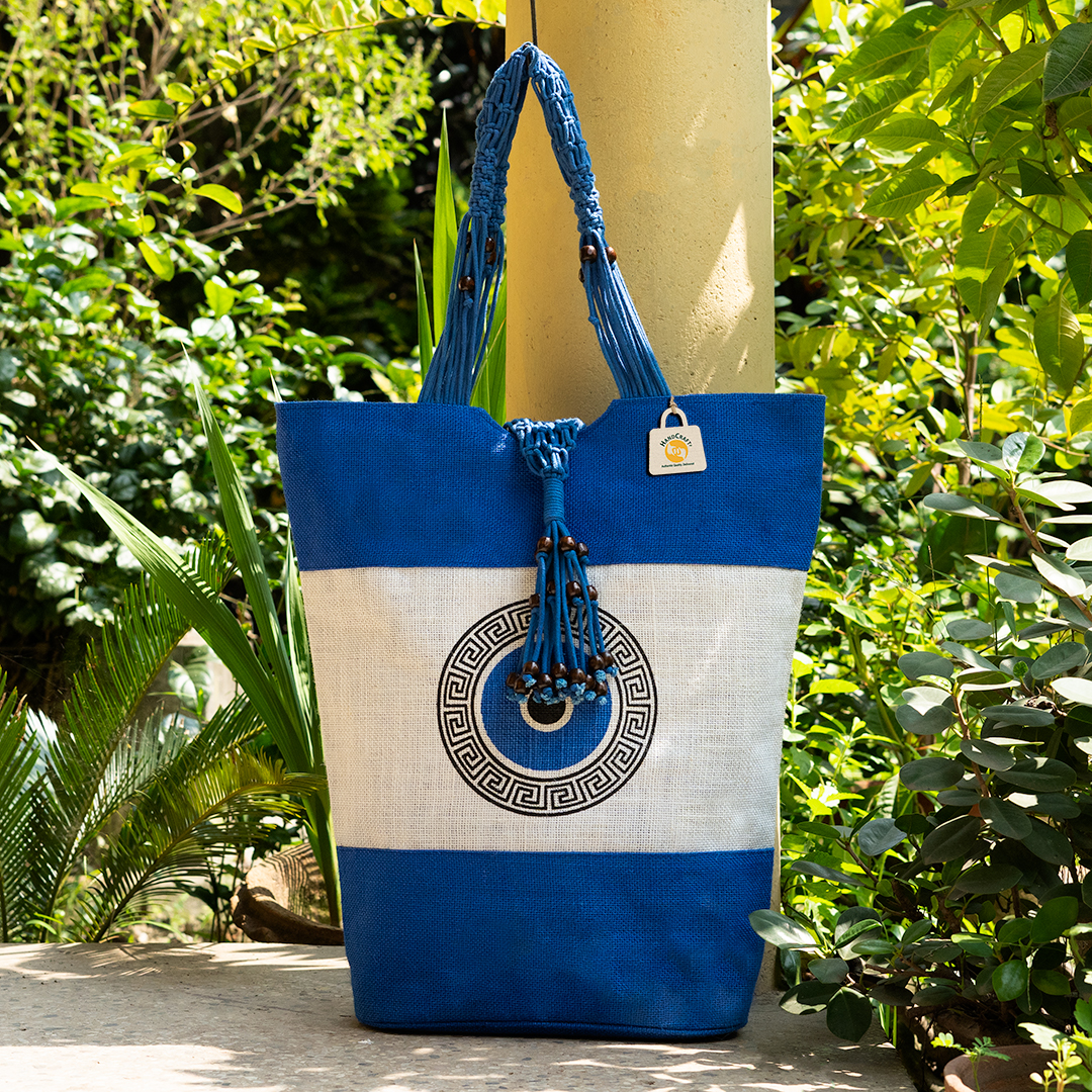 Blue and pale-panel tote with a geometric motif and decorative handle ties.