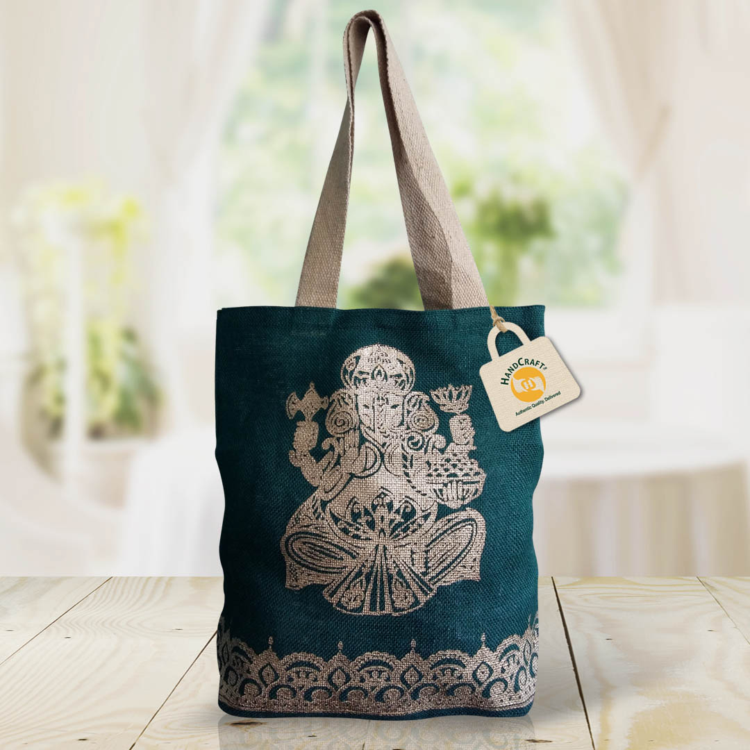 Dark teal bag with a printed Ganesha motif and flat natural-colour handles.