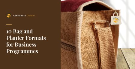 Side view of a natural jute sling bag with cream trim, a maroon interior, a zip pocket and a strap fitted through a metal loop.