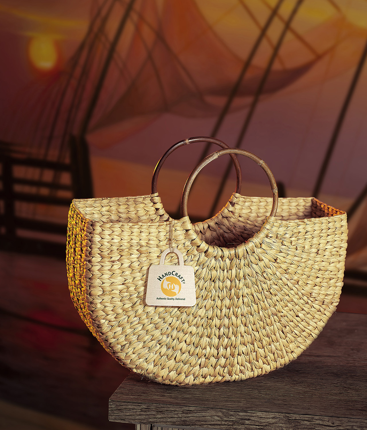 Woven basket bag with rigid curved handles.