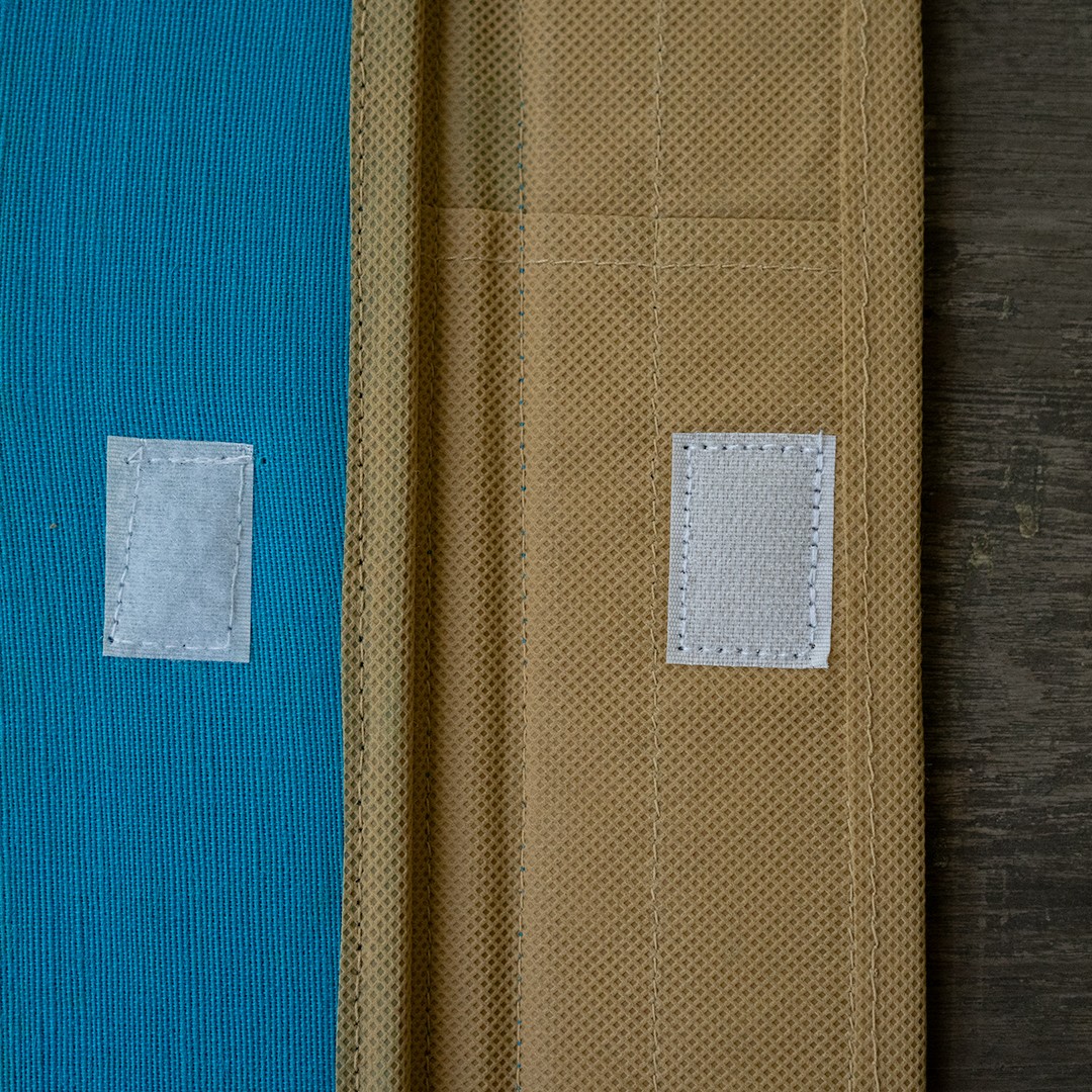 Document folder with blue trim and a hook-and-loop fastening.