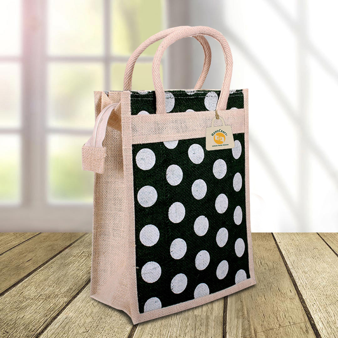 Bag with a black and white polka-dot design and pale handles.