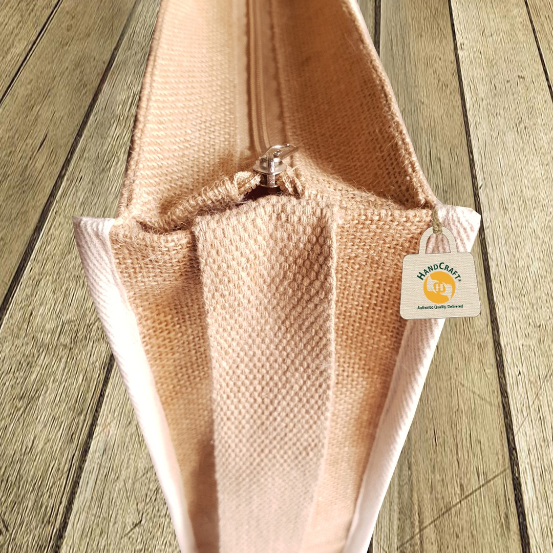 Close-up of a zip along the top of a natural-colour bag.