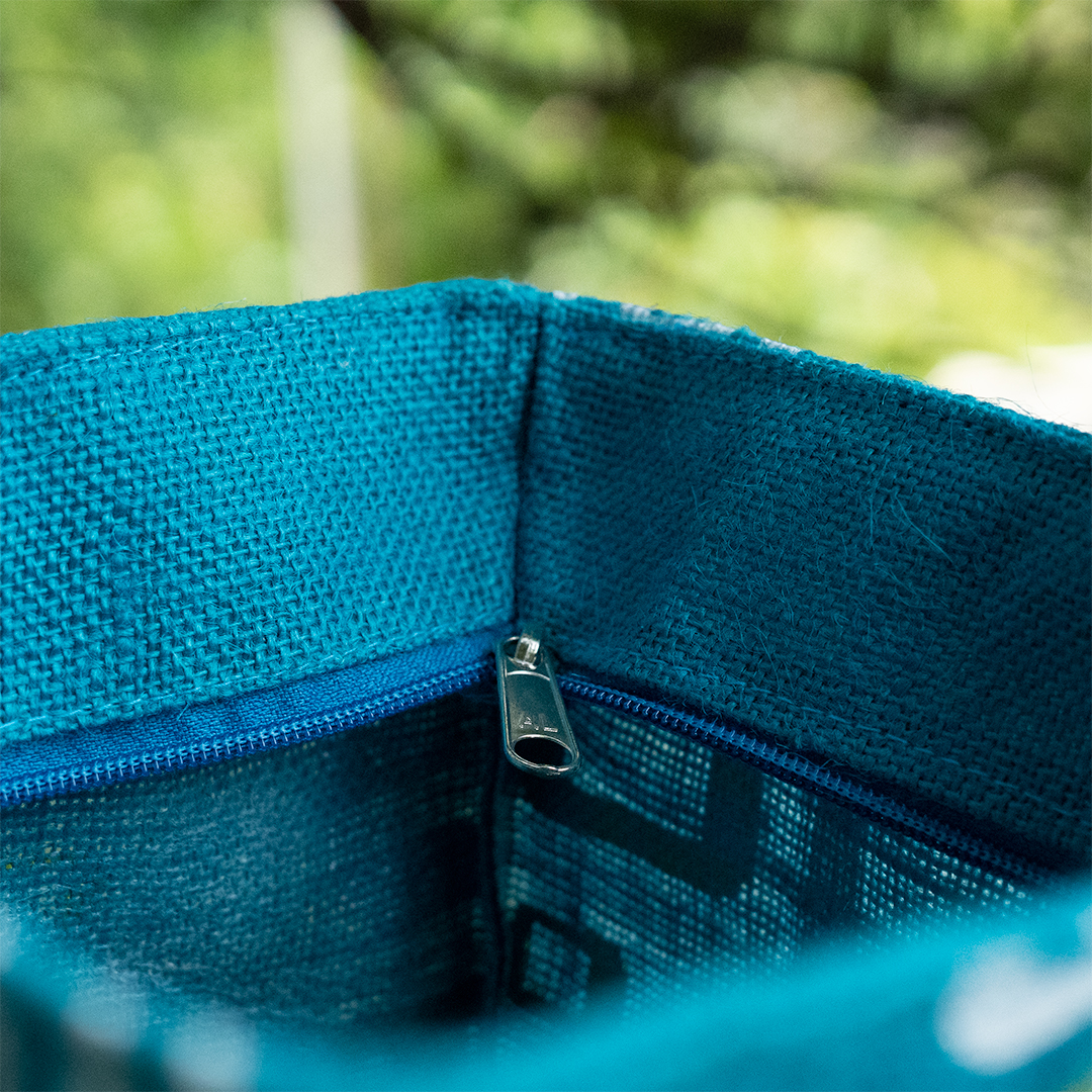 Close-up of a turquoise bag zip and interior.